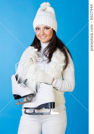 Beautiful woman in winter clothes with skates. 6027444