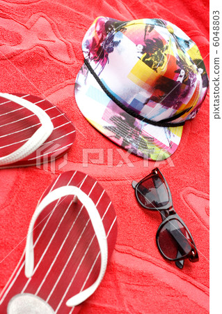 Flip flops, sunglasses and a cap 6048803