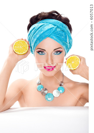Smiling beautiful woman holding fresh lemon - wholesome food 6057013