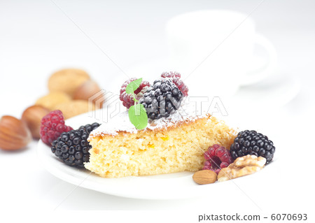 cup, cake, raspberry, blackberry,nuts and mint on a plate on a w 6070693