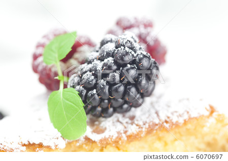 cup, cake, raspberry, blackberry,nuts and mint on a plate on a w 6070697