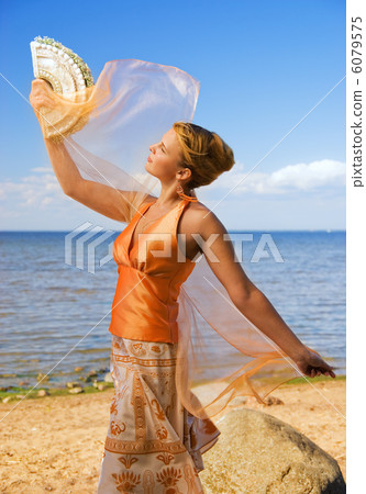 Beautiful redhead girl on the beach at sunny day Beautiful redhead girl on the beach at sunny day 6079575