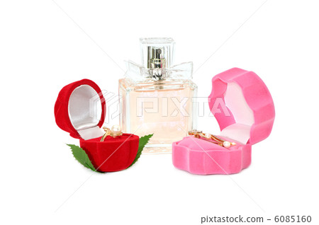 Gold ornaments and bottle of perfume isolated on white background Gold ornaments and bottle of perfume isolated on white background 6085160