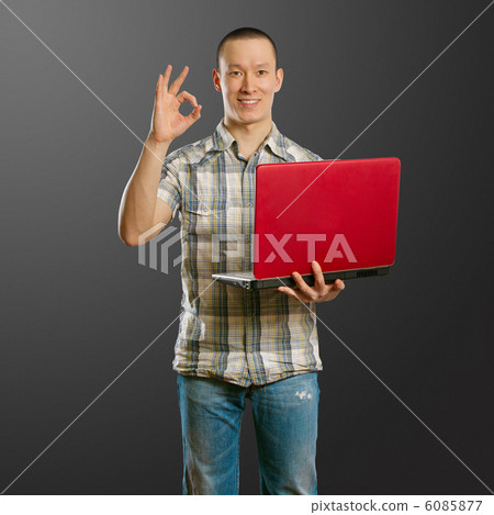 asian male with laptop in his hands shows OK asian male with laptop in his hands shows OK 6085877