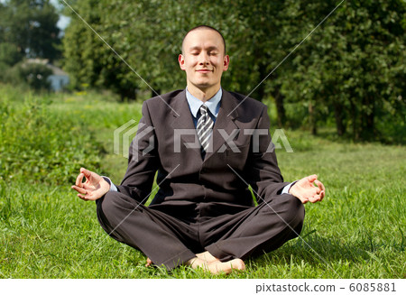 Businessman Meditating Outdoors Businessman Meditating Outdoors 6085881