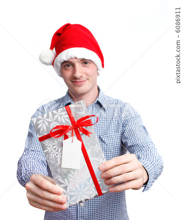 Man with santa hat holding christmas present Man with santa hat holding christmas present 6086911