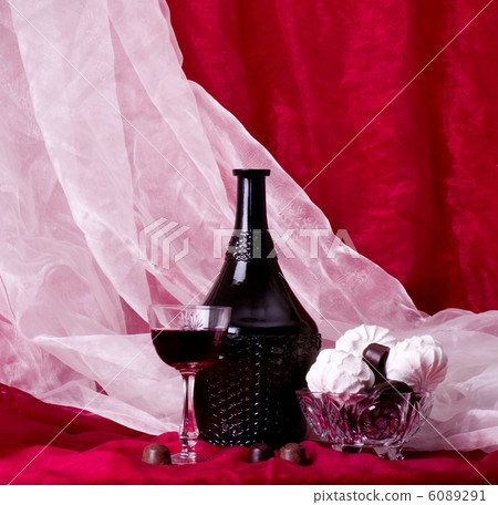 beautiful composition with the bottle of wine and sweetnesses in a vase beautiful composition with the bottle of wine and sweetnesses in a vase 6089291