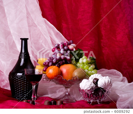 Beautiful composition with fruits on vase on red background 6089292