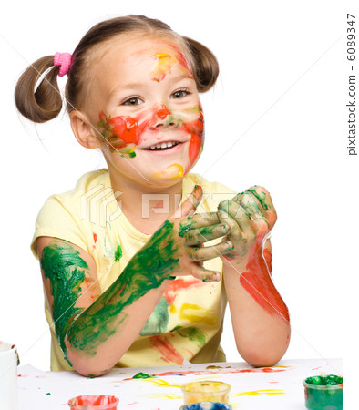 Portrait of a cute girl playing with paints 6089347