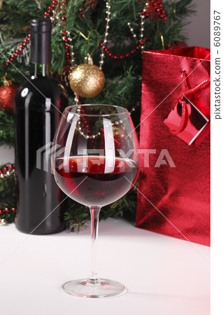 red wine, christmas tree and bag with gift 6089767