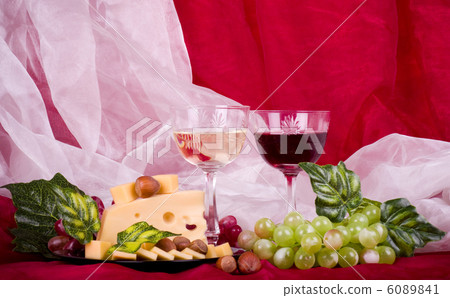 Beautiful composition with wine, grape and cheese on red background 6089841