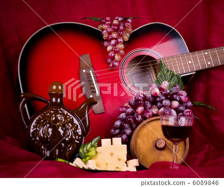 Beautiful composition with wine, grape, cheese and guitar on red background 6089846