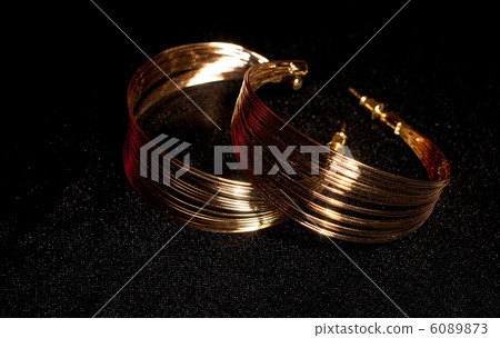 Golden jewelry on black background 6089873
