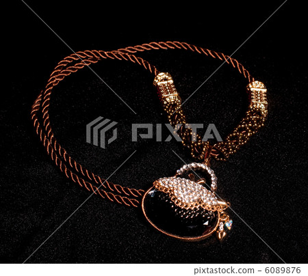 Golden jewelry on black background Golden jewelry on black background 6089876