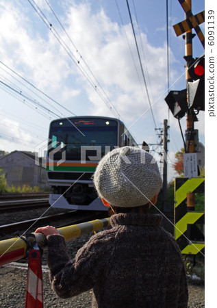 Child waiting at train and railroad crossing Child waiting at train and railroad crossing 6091139