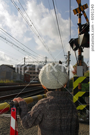 A child waiting at a railroad crossing 6091140