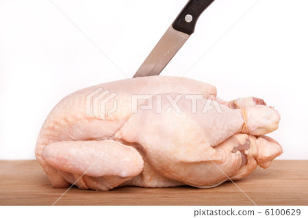 uncooked chicken with knife on wood board 6100629