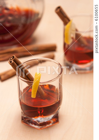 glass heating red liqueur with cinnamon sticks glass heating red liqueur with cinnamon sticks 6100655