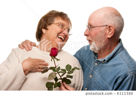 Happy Senior Husband Giving Red Rose to Wife Happy Senior Husband Giving Red Rose to Wife 6111380