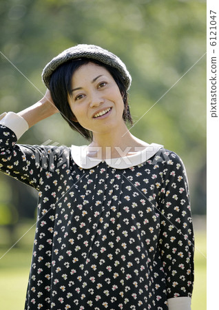 A woman holding a hat A woman holding a hat 6121047