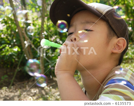 Boy playing soap bubble Boy playing soap bubble 6135573