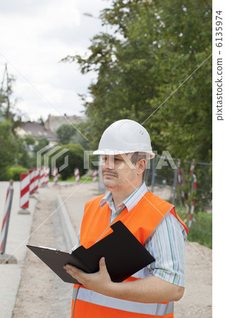 Engineers with folders near the repair sidewalk 6135974