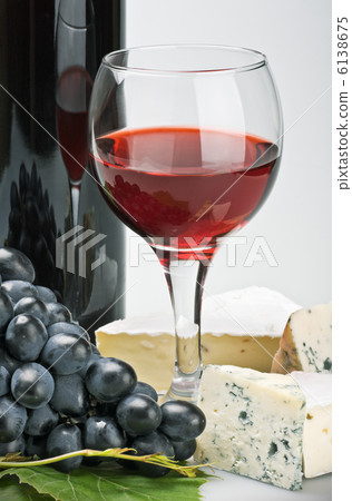 glass of red wine with bottle 6138675