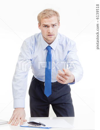 angry boss behind desk 6139518