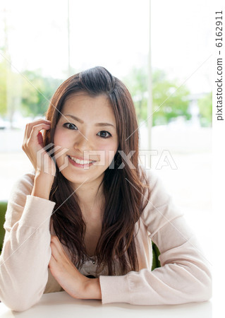 A woman relaxing at a cafe 6162911