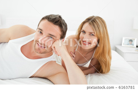 Couple lying down together in their bed Couple lying down together in their bed 6163781