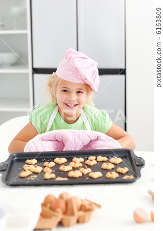 Adorable little girl shoing her cookies to the camera 6163809