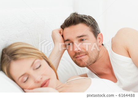 Boyfriend looking at his girlfriend who is  sleeping 6164488