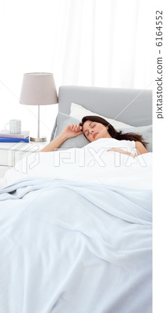 Serene mother sleeping peacfully on the bed 6164552