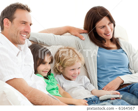 Parents and children watching television together Parents and children watching television together 6164567