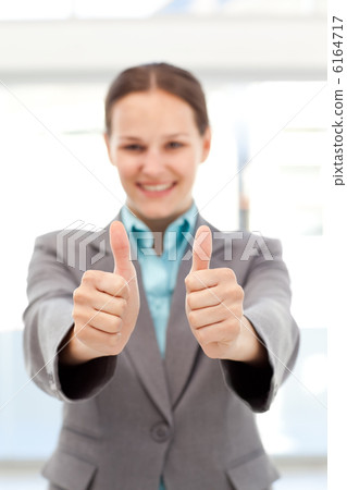 Successful businesswoman doing thumbs up 6164717