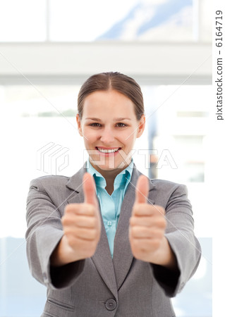 Proud businesswoman doing thumbs up 6164719