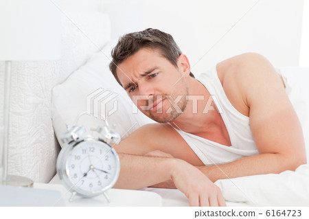 A man in his bed before waking up 6164723