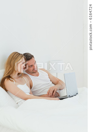 Lovers watching a movie on their laptop Lovers watching a movie on their laptop 6164724