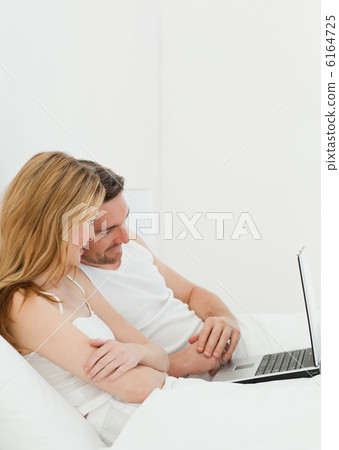 Lovers watching a movie on their laptop Lovers watching a movie on their laptop 6164725