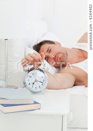 A unhappy man in his bed before waking up 6164982