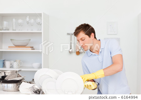 Man washing dishes 6164994