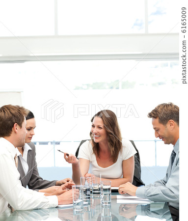 Cheerful manager talking to her team during a meeting