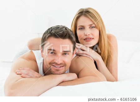 Lovely pairs lying down together in their bed at home Lovely pairs lying down together in their bed at home 6165106