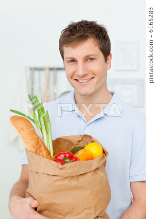 Man with shoping bags in the kitchen Man with shoping bags in the kitchen 6165283
