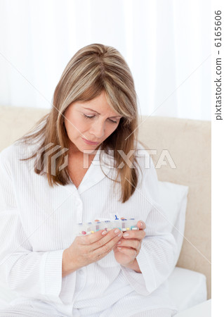 Sick woman taking her pills at home 6165606