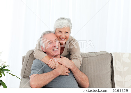 Lovers hugging while they are looking at the camera Lovers hugging while they are looking at the camera 6165859