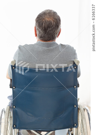Mature man in his wheelchair with his back to the camera Mature man in his wheelchair with his back to the camera 6166337