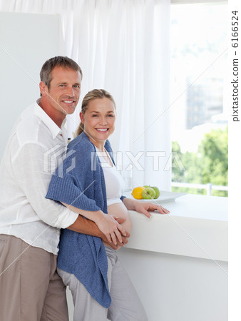 Young couple looking at the camera while they are hugging Young couple looking at the camera while they are hugging 6166524