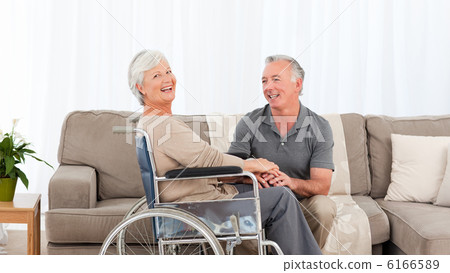 Man with his wife in a wheelchair Man with his wife in a wheelchair 6166589