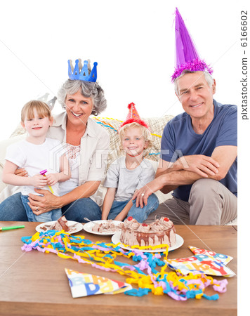 Happy family looking at the camera on a birthday Happy family looking at the camera on a birthday 6166602